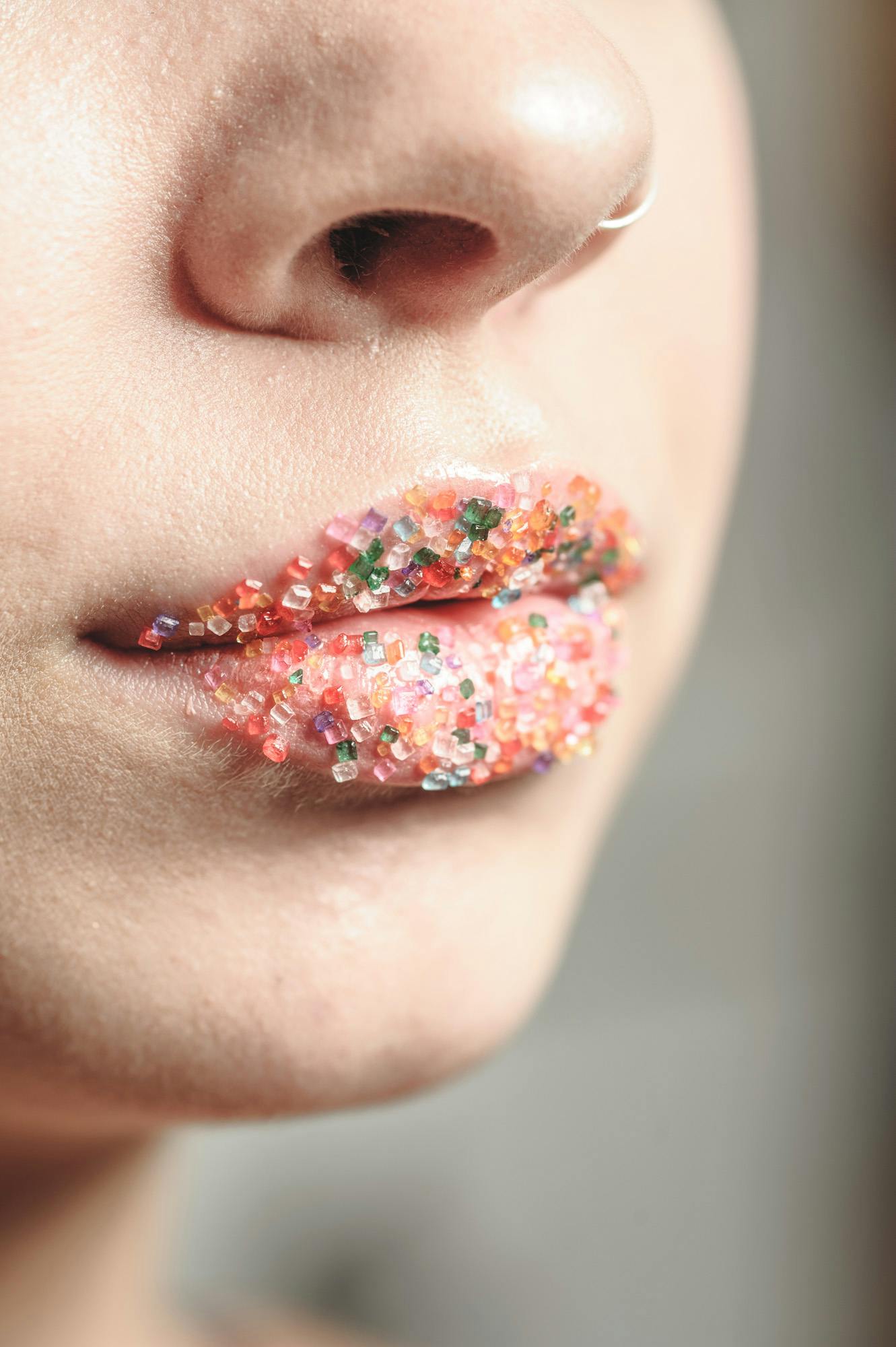 a close up portrait of Caty's lips with candied glitter covered lips.